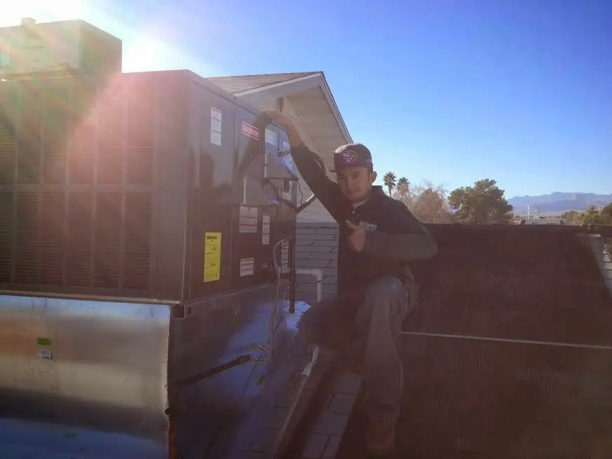 HVAC technician performing AC Tune-Up on a rooftop unit in Downingtown